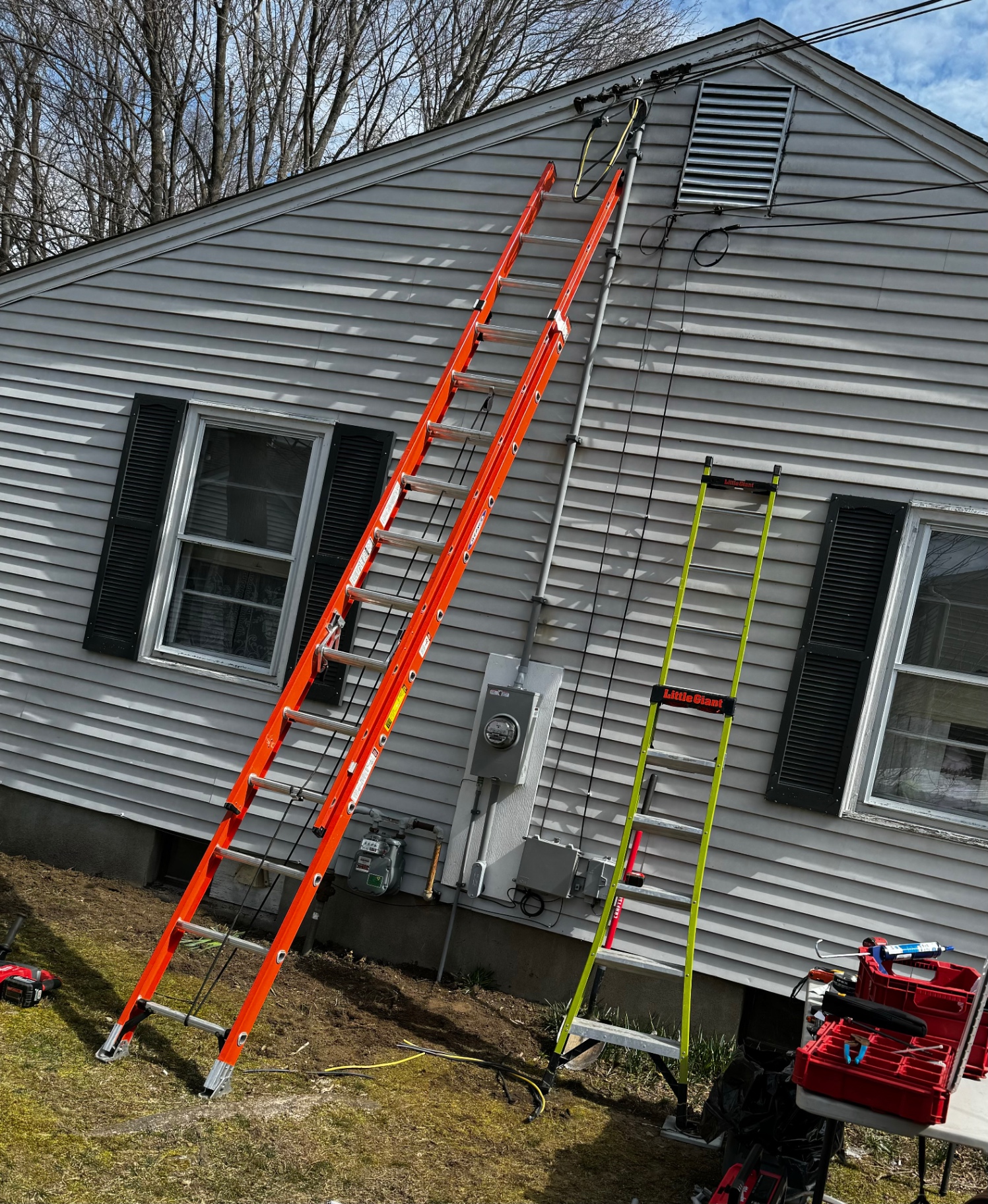 Residential service upgrade worksite with ladders
