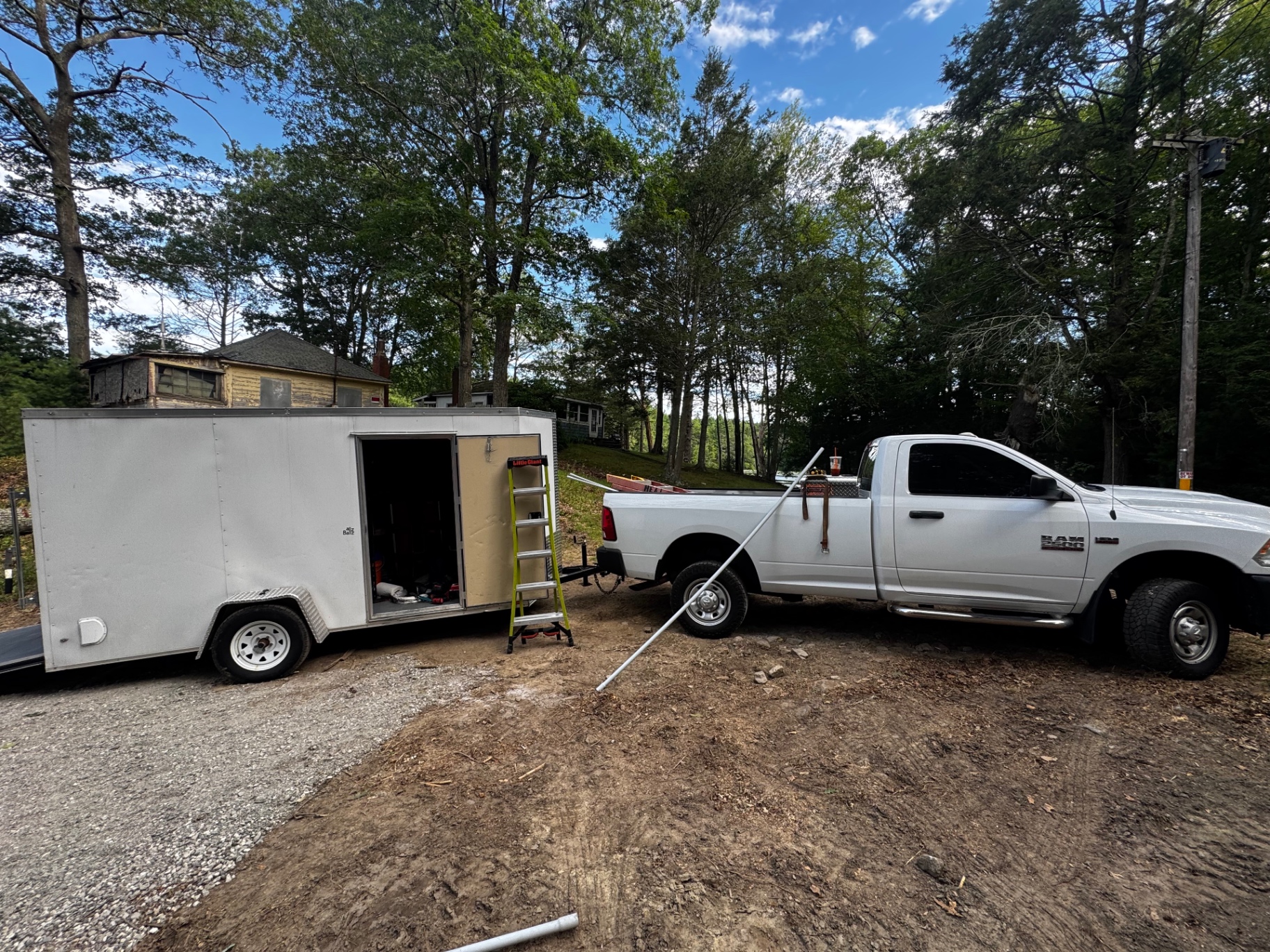 Hevy Electric work truck and enclosed trailer at a local jobsite