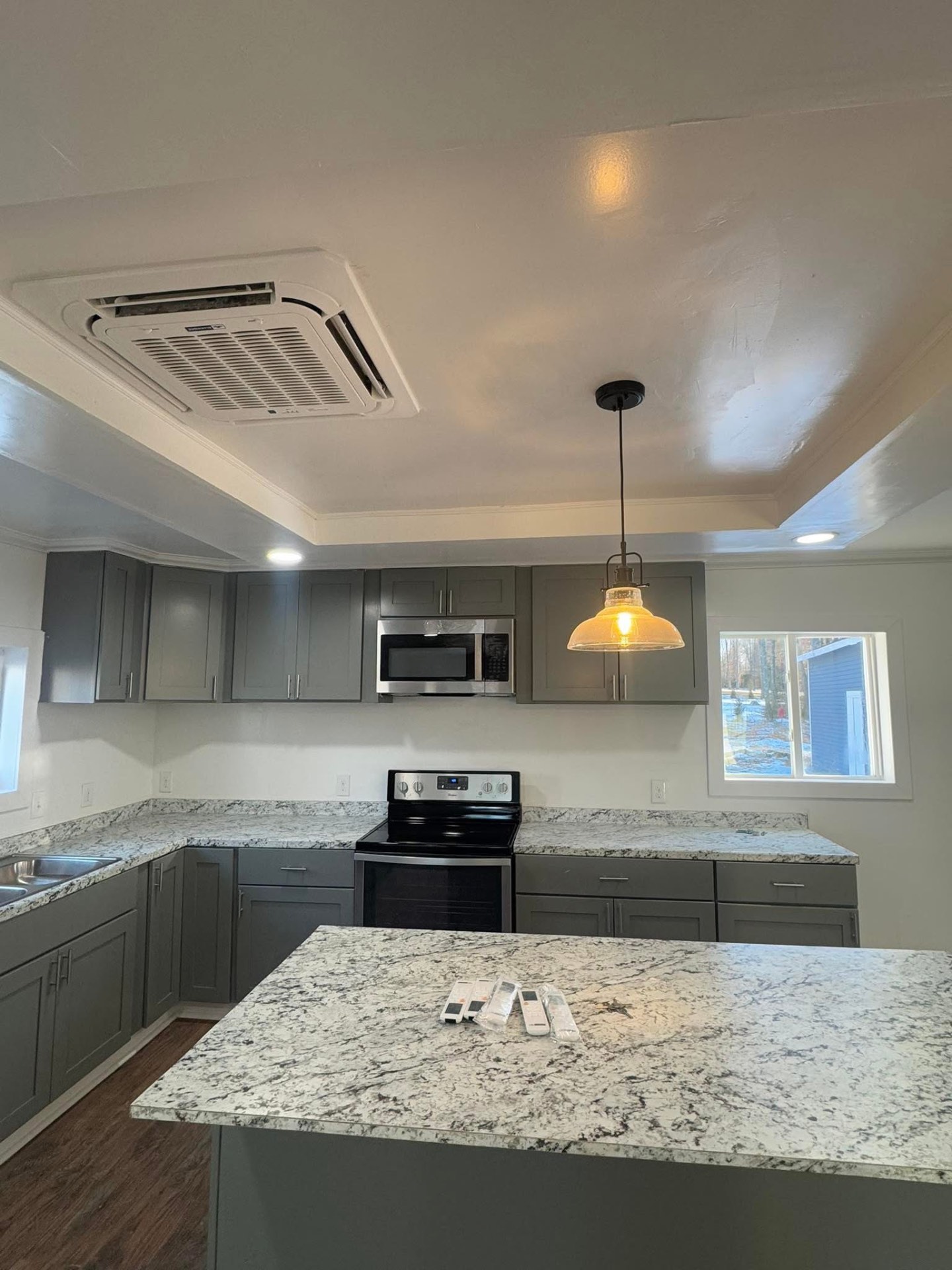 Finished kitchen with ceiling cassette and pendant lighting